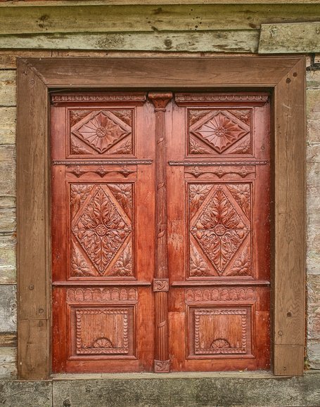 Wieś Borzynowo - ozdobne drzwi drewnianego domu.