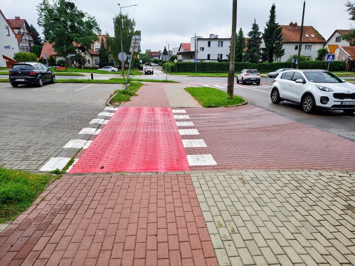 Formuła I dla rowerzystów i użytkowników hulajnog. Ul. Broniewskiego /na wysokości marketu i banku/ wjazd na parking. wzorcowa ścieżka dla rowerzystów a piesi pasów nie mają i powinni uprawiać skok w dal lub trójskok. Panuje tu duży ruch.i kwestią  czasu jest wypadek. Podobnie jest w wielu innych miejscach gdzie na przecięciu ścieżki rowerowej i chodnika dla pieszych brak jest pasów. Nota bene zgodnie z wymogami  unijnymi ścieżka rowerowa powinna być przy pasie drogowym czyli odwrotnie. Tak jest na całej ulicy Niepodległości. Kto za to ponosi odpowiedzialność.?    .